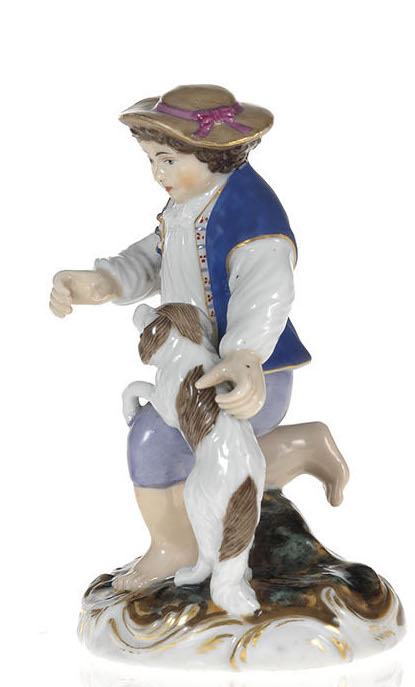 A Porcelain Figurine of a Boy with a Playful Puppy