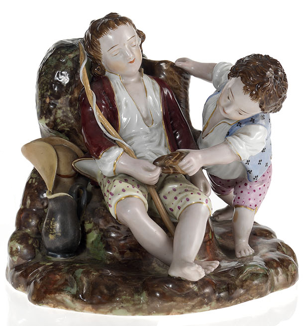 A Porcelain Composition of a Child Teasing a Sleeping Friend