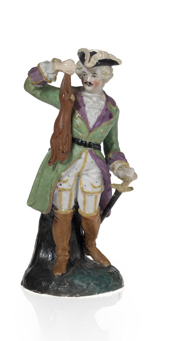 A Biscuit Porcelain Figurine of an 18th Century Huntsman with His Prey 
