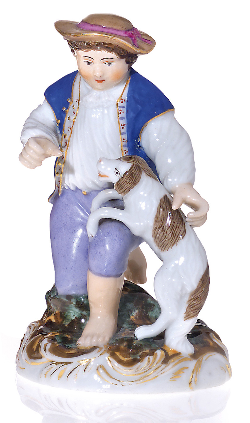 A Russian  Porcelain Figurine of a Boy with a Playful Puppy