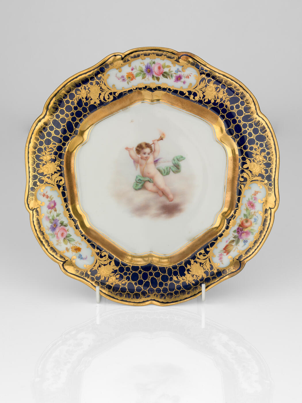 A Porcelain Dessert Plate with Angel Putti