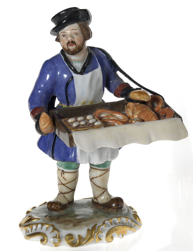 A Porcelain Figurine of a Bread and Pretzels Vendor