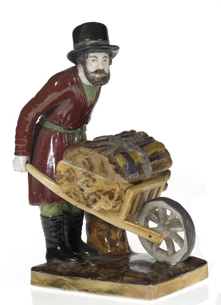 An Inkwell in the Shape of a Lumberjack with His Wheelbarrow