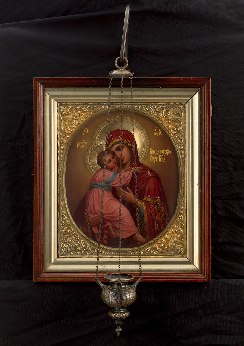 The Mother of God of Vladimir in a Silver-Gilt Chiselled Frame, Wooden Kiot and with a Lampion