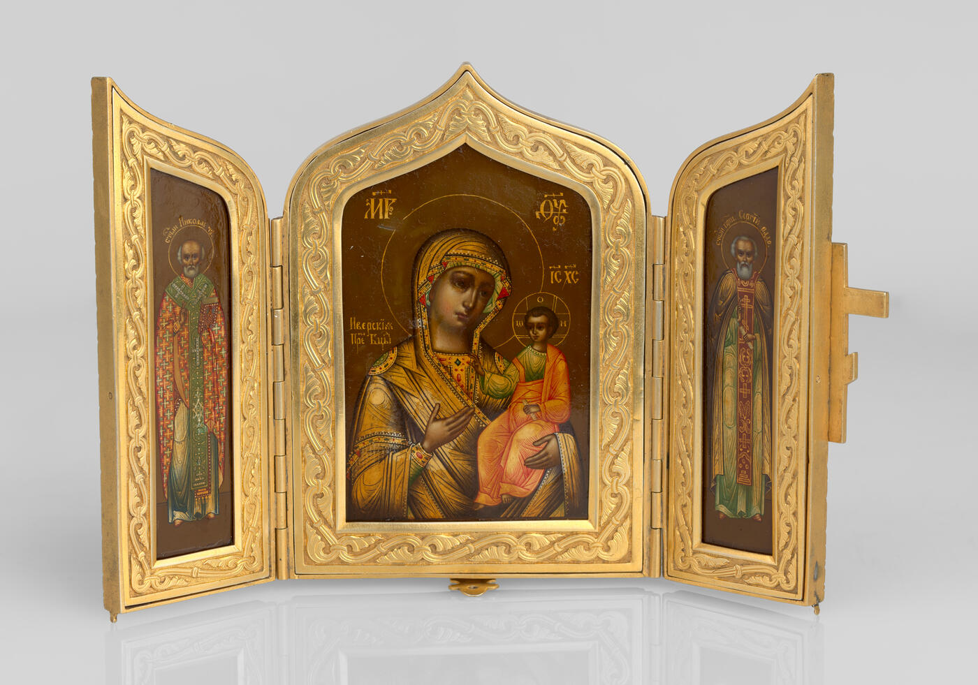 A Silver-Gilt Triptych of the Iverskaya Mother of God, St Nicholas the Miracle-Worker and Sergei of Radonezh with Enamelled Cross