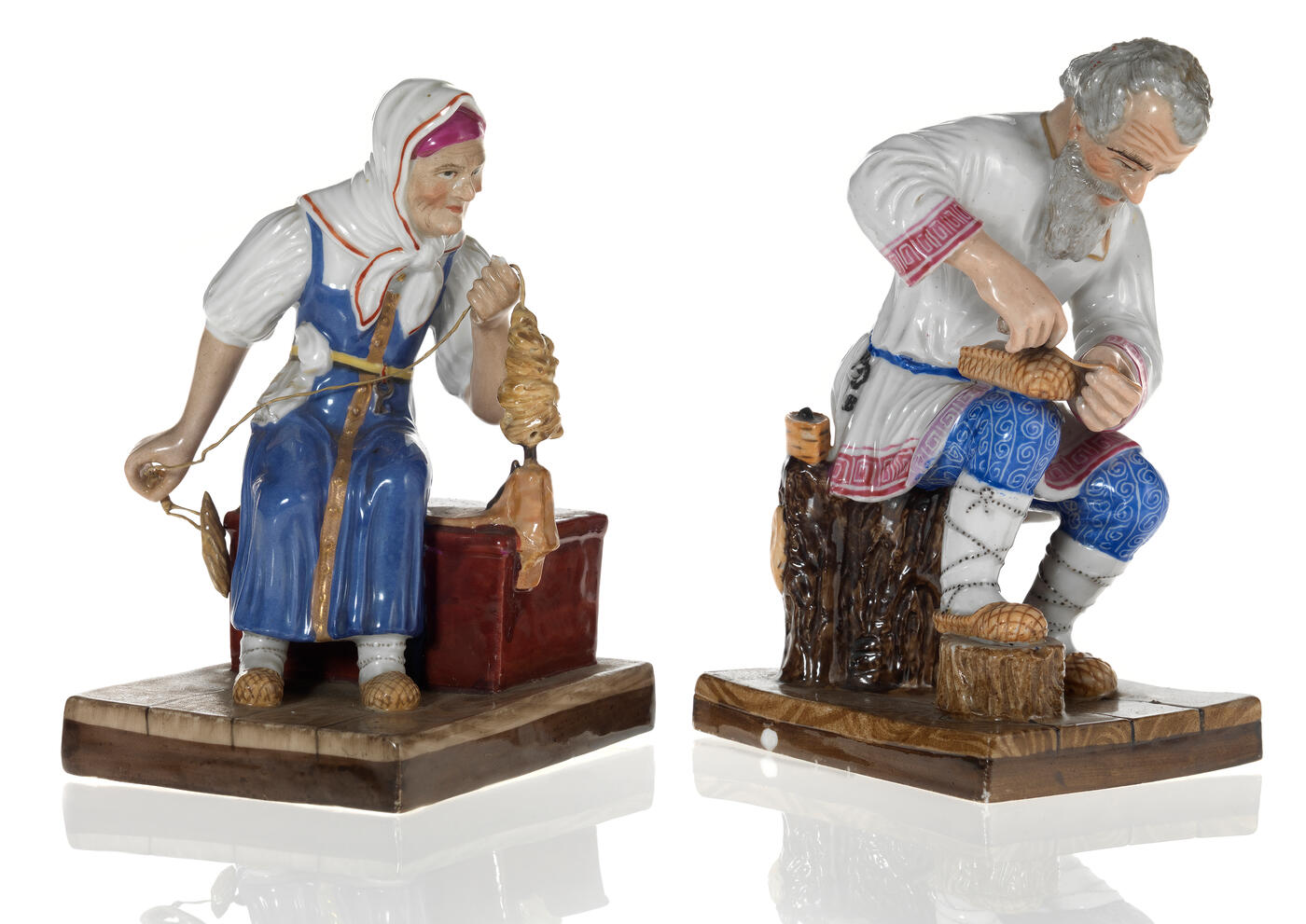Two Porcelain Figurines of a Peasant Woman Spinning and an Old Man Making a Bast Shoe