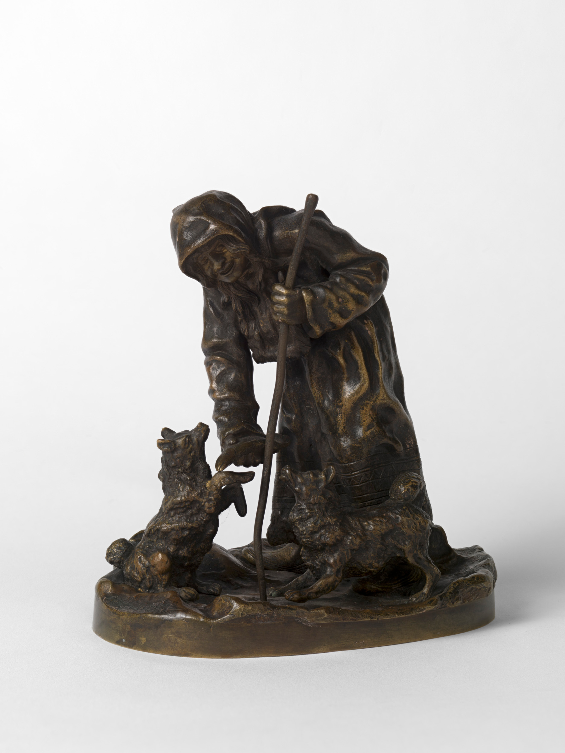 A Bronze Group of an Aleutian Woman Feeding Dogs.